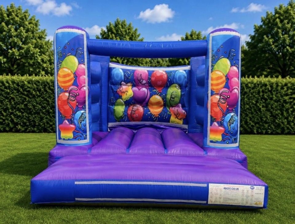 Purple and blue bouncy castle with colourful party balloon artwork