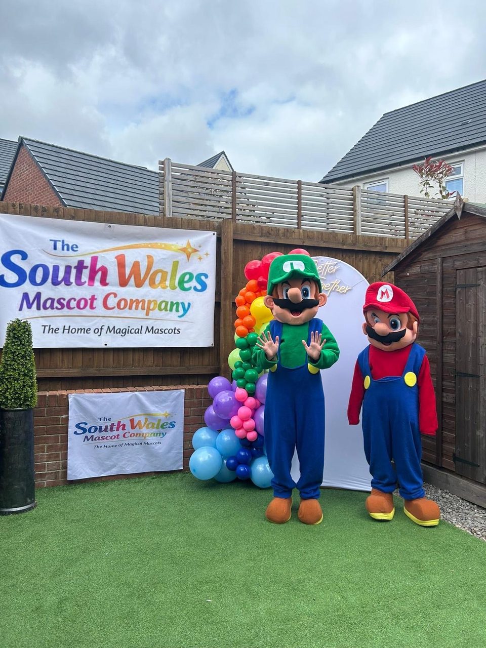 Mario and Luigi lookalike mascots in caps and blue dungarees