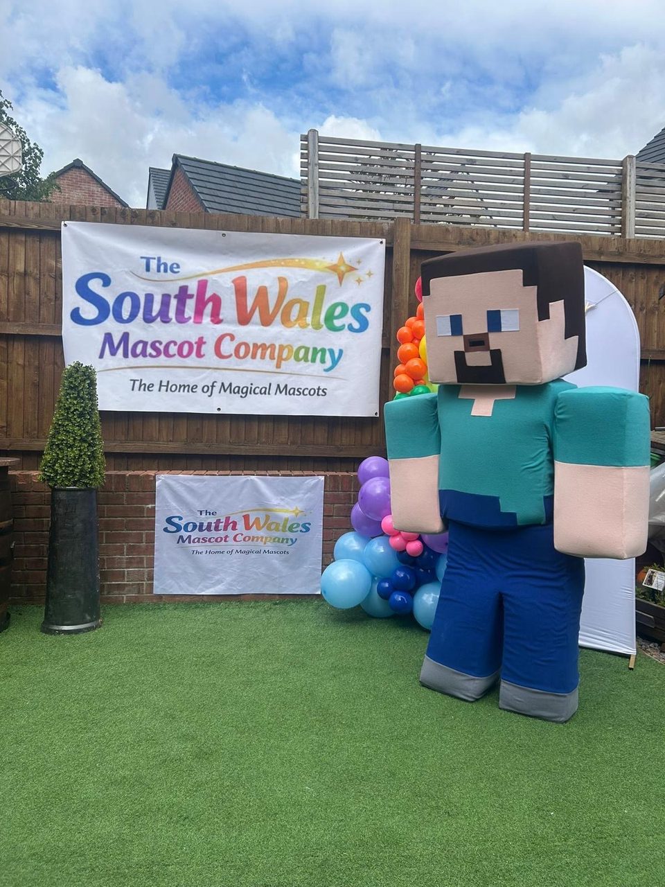Blocky Steve lookalike mascot with a square head and teal shirt