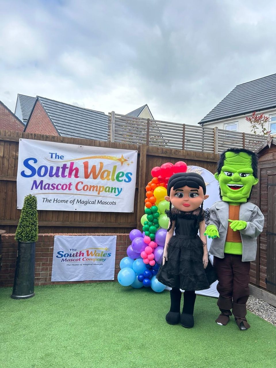Wednesday and Frankenstein lookalike mascots standing side by side